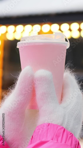 Festive hot beverage. Vibrant marketplace adorned with bright illumination and steaming drinks. Joyful holiday scene showcasing luminous decorations and comforting hot chocolate beverages