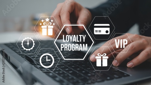 Close up of hands typing on laptop accessing online loyalty program and digital rewards