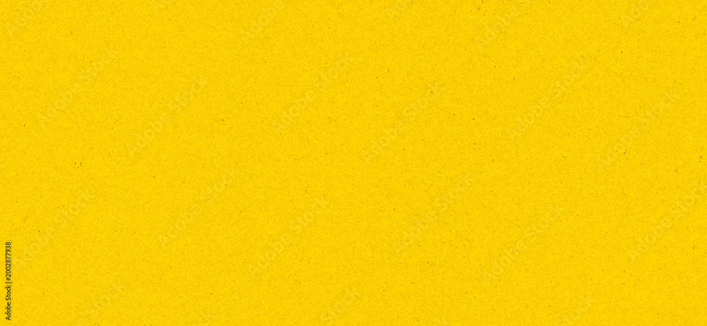 Obraz premium Bright yellow background with paper texture and visible grain, abstract surface for modern design and advertising.