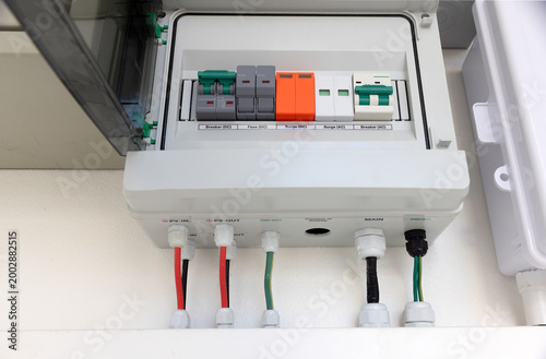 Solar Combiner Box on a House Wall with Integrated DC and AC Safety Components (Breakers, Fuses, Surge Protection) for a Hybrid PV System.