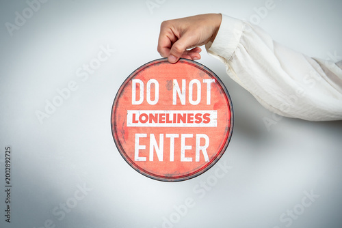 Do Not Enter Loneliness Warning Sign Held by Hand Isolation Concept