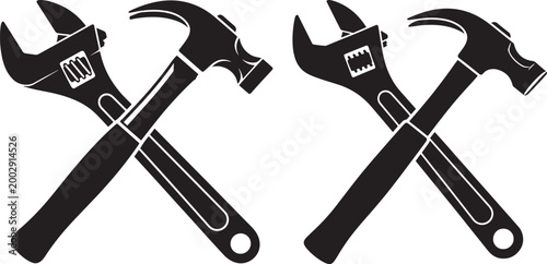 Crossed wrench and hammer silhouetted in black and white with tool kit silhouette industry construction mechanic building handyman equipment hardware workshop engineering craftsmanship