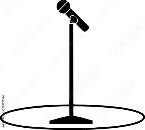 The theatrical stage features a sleek, black microphone stand with a circular spotlight base, perfectly positioned for a solo performance or monologue