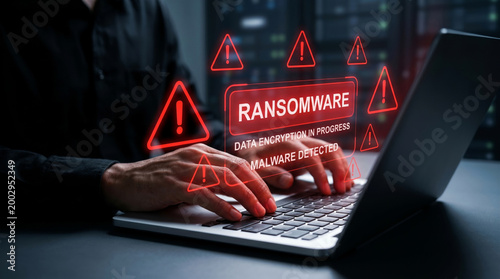 Hacking and ransomware concept with laptop user facing cyber extortion and data encryption alert