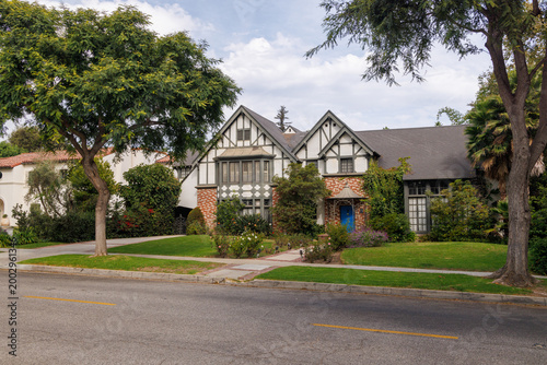 Modern suburban houses with cars in quiet residential street