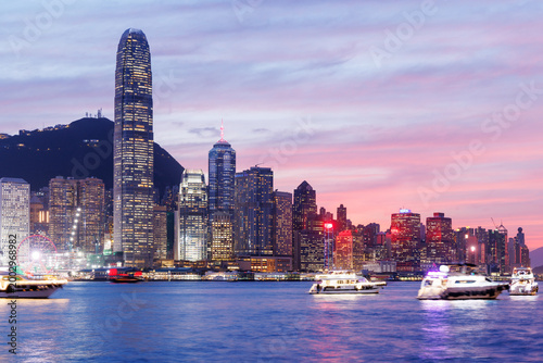 Photography Hong Kong city skyline at sunset with glowing sky and skyscrapers