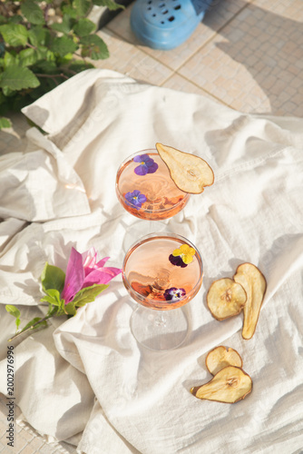 Rose wine glasses on tropical background. Summer cocktails