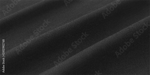 The textured surface of a dark fabric displays gentle waves and subtle folds, hinting at the depth and softness of the material.