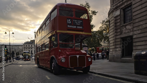 Vászonkép Red double decker bus driving on london street