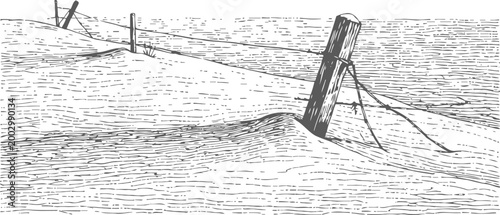 Barbed wire fence post in snowy winter landscape with drifts and barren fields