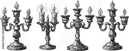 Vintage ornate candelabras set with lit candles, antique decorative metal candle holders collection