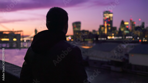 Photography Man silhouetted contemplating london city skyline at sunset