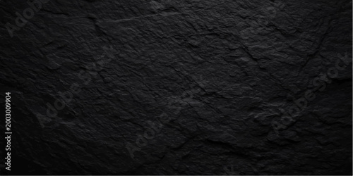 Black leather texture and dark material pattern surface create a macro textured skin design for a grey fabric backdrop or rough paper wallpaper background