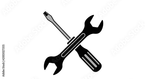 A crossed arrangement of a black screwdriver and an adjustable wrench on a stark white background