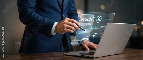Business professional engaging with digital policies on laptop modern office setting informative content display clear perspective technology integration
