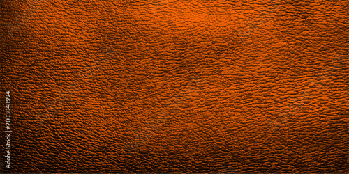 A macro closeup of a rough brown leather material texture with a grunge skin pattern and aged structure for a textured wallpaper backdrop