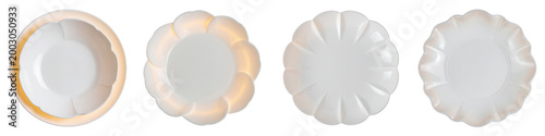 Four elegant white ceramic plates with decorative scalloped edges arranged in  row