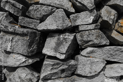 Stacked gray stones rubble texture background.