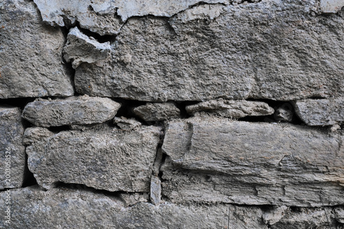Old stone wall texture, stacked rough rocks background with natural pattern.