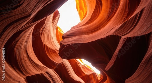 Sunlight filters through sandstone canyon walls creating wavy patterns