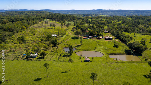 Fotografi Aerial view of rural farm with pasture, ponds and buildings in agricultural landscape