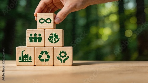 Business man stacking wooden blocks with recycling sustainability and environmental icons green concept for eco friendly company responsibility strategy and global welfare