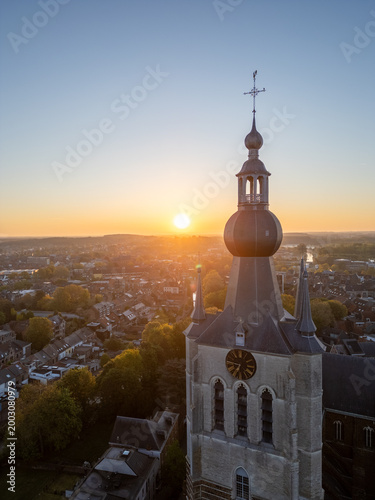 Photos Historic church bell tower at sunrise in Aarschot, België - aerial drone view of