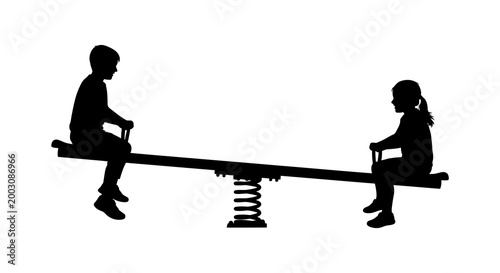Childhood fun silhouette of two children playing on a seesaw in a park