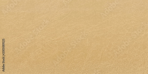 A detailed texture of a beige leather surface, providing a close-up view of its natural grain and subtle imperfections, suggesting luxury and sophistication.