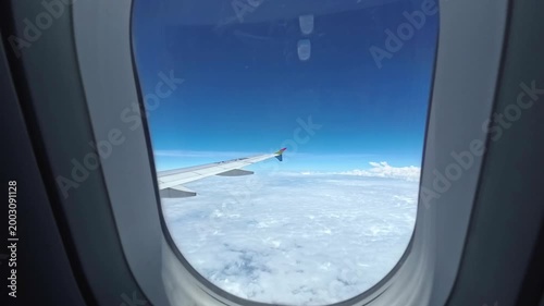 View from the window of an airplane flying in a beautiful cloudy sky