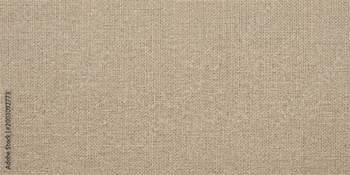 A close-up captures a beige woven textile, showcasing the subtle texture and natural tones. The neutral canvas offers versatility for design and background purposes.