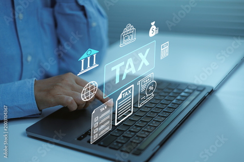 Business professional using laptop with digital tax management interface, online tax filing , accounting documents , financial planning, corporate compliance, fintech services and audit reporting