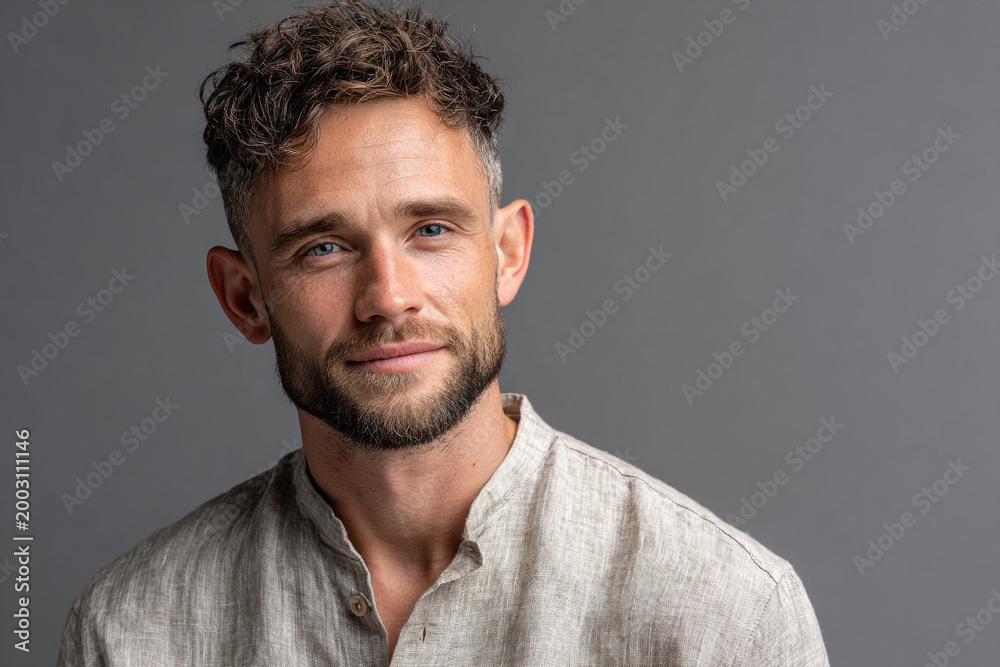 Fototapeta premium Professional headshot of a charming 23-year-old man with blue eyes and beard