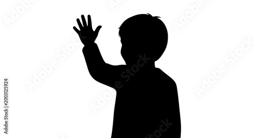 Silhouette of a young boy waving.