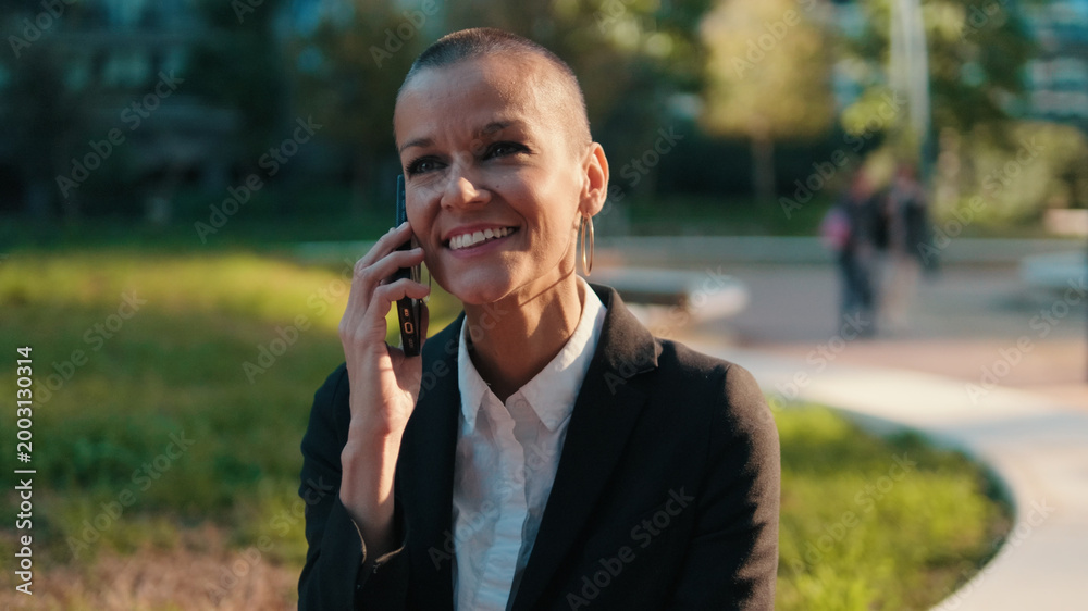 Fototapeta premium Smiling Business Woman On Phone In Park