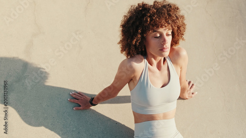 Woman Exercising Outdoors Against Wall