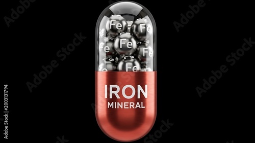 Iron mineral supplement capsule with tiny iron spheres inside, representing a health and wellness concept