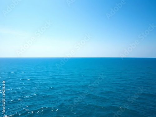 Vast, serene ocean expanse under a clear sky, tranquil blue waters stretching to the horizon,  azure,  deep