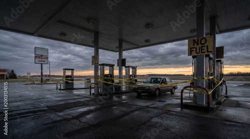 Abandoned gas station with no fuel sign at dusk