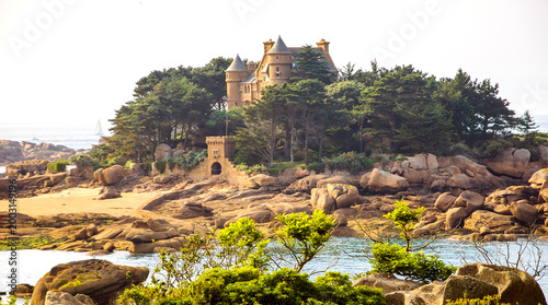 Breton landscape with castle on Pink Granite Coast near Ploumanac’h, Brittany, France. Natural and cultural tourism travel destination.