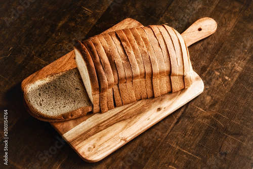 Whole wheat  bread on wooden background