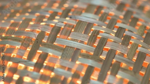 Warm Light Glowing Through Woven Bamboo Texture – Close Up Abstract