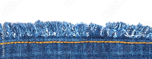 Bild auf Leinwand Frayed edge of denim fabric shows blue threads and seam with yellow stitching du