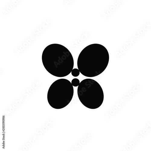 Four black ovals arranged in a symmetrical flower pattern with two small dots
