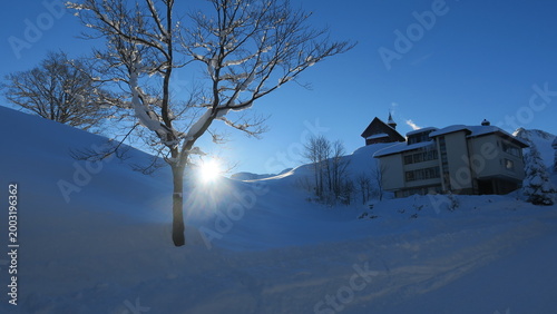 Bright sun shines on a snow...