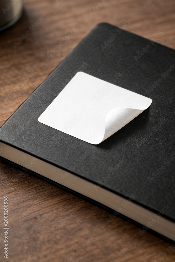 Fototapeta premium Peeling Sticker on Black Notebook Cover