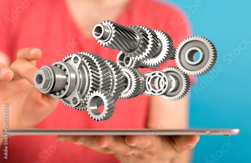 Person holding 3D gears con...