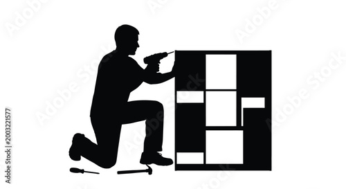 Silhouette vector illustration of a tradesperson kneeling while using a power drill to assemble furniture modules