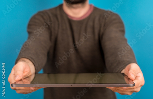 Person holding tablet, offe...