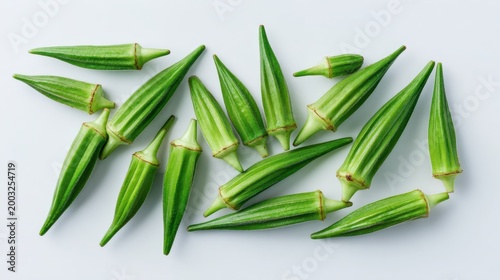 Top-down shot of okra pods with green roselle calyces on a white backdrop